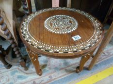 A round occasional table inlaid with bone