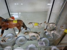 A Beswick hunter on horseback with hounds A/F