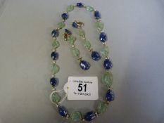 Necklace and earring set, cabochon Sapphire,sculptured Emeralds in the form of leaves and Diamonds