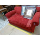 A red upholstered drop arm Sofa