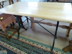 A rectangular table with cast iron base