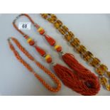 A Coral Necklace, an amber style necklace and one other