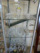 A suite of Webb Glasses - Decanter and glasses set- on three shelves