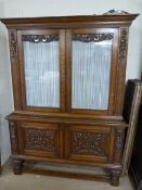 A carved oak display cabinet