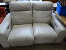 A cream two seater electric recliner sofa