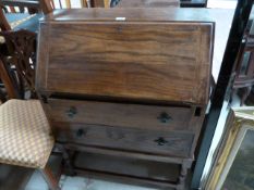 An oak bureau with two drawers under