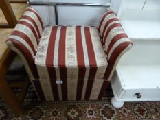 An upholstered footstool with storage under