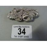 A stunning Diamond dress clip, set in platinum. the dress clip is set with approximately 180