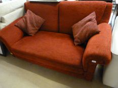 A red two seater drop arm sofa