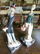 A pair of 50s style lady figurines on marble bases- indistinct signature to reverse