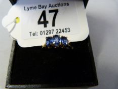 A blue Topaz three stone ring set in 9 ct gold