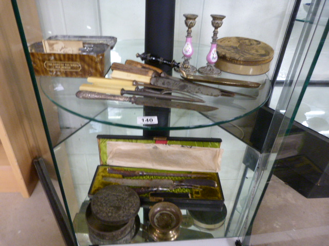 A quantity of misc items inc tins, carving set etc - over two shelves