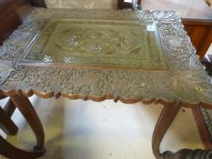 A carved occasional table with pierced copper tray insert