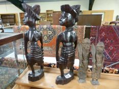 A pair of metal african figures and a wooden pair