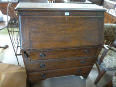 An oak bureau with drawers under