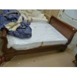 A large double sleigh bed and mattress