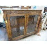 A leaded glass fronted display cabinet