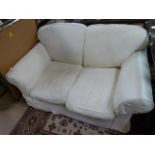 Large 2 seater cream sofa with extra loose covers