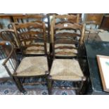 Set of four oak dining chairs with rush seats