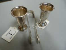 A pair of silver sugar tongs, and two small silver vases (weighted) - weight of tongs 47.3g