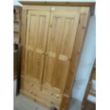 A double pine wardrobe with drawers underneath