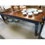 A large pine farmhouse table with painted base