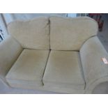 A brown patterned two seater sofa