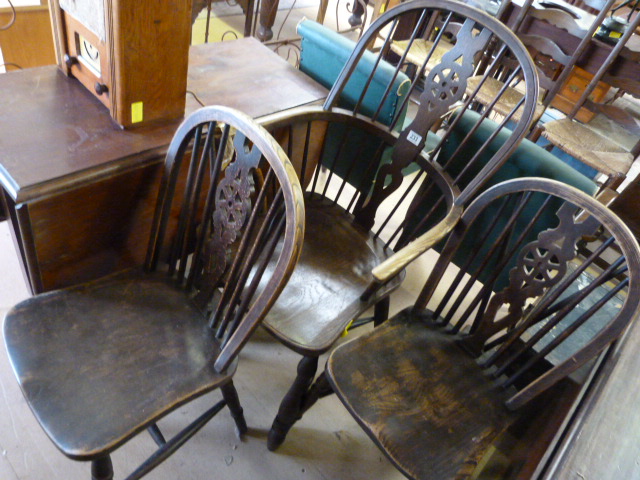 Wheelback carver with curved stretcher and two similar dining chairs