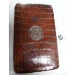 A crocodile skin cigar case with silver monogram, made by Asprey & Co.
