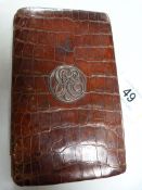 A crocodile skin cigar case with silver monogram, made by Asprey & Co.