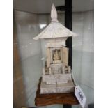 An early 20th century ivory pagoda with opening doors and seated deity