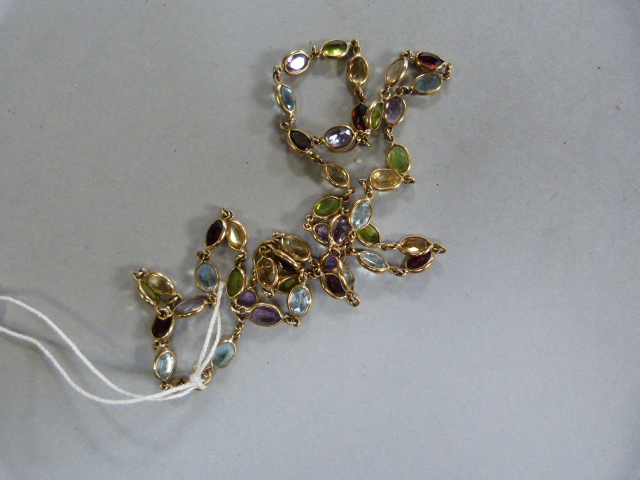 A 9ct chain decorated with various semi precious stones- Peridot, Amethyst,Topaz, Aquamarine etc. - Image 2 of 3