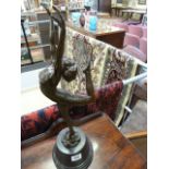 A bronze of an Art Deco style lady on one leg on a plinth