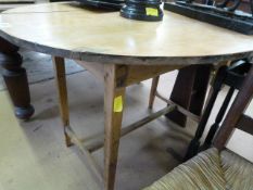 An antique pine oval dining table