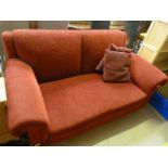 A red two seater drop arm sofa