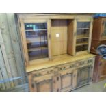 An oak three door glazed dresser