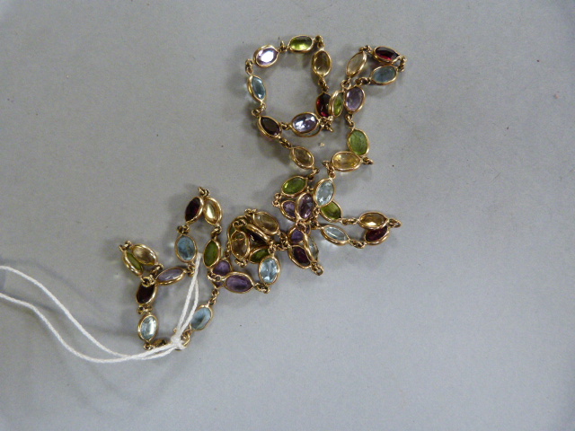 A 9ct chain decorated with various semi precious stones- Peridot, Amethyst,Topaz, Aquamarine etc. - Image 3 of 3