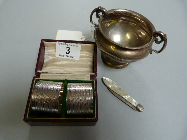 Pair of hallmarked silver napkin rings, silver bladed fruit knife and a small silver cup ( A/F)