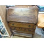 An oak bureau with two drawers under