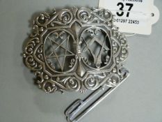 A white metal Masonic nurses belt buckle