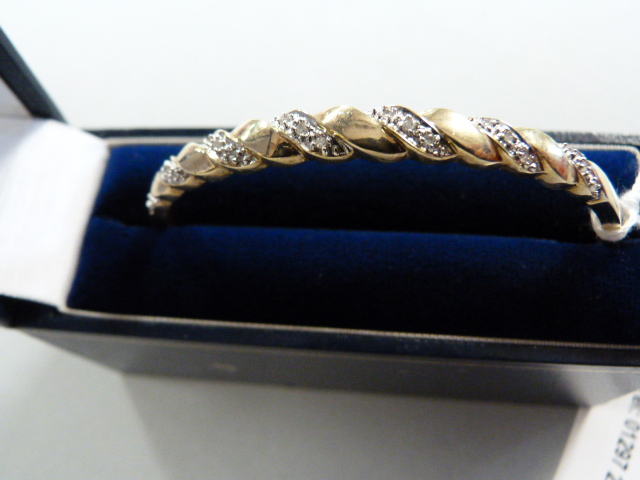 A 9ct hinged bangle set with diamonds - total weight 9.8g - Image 3 of 3