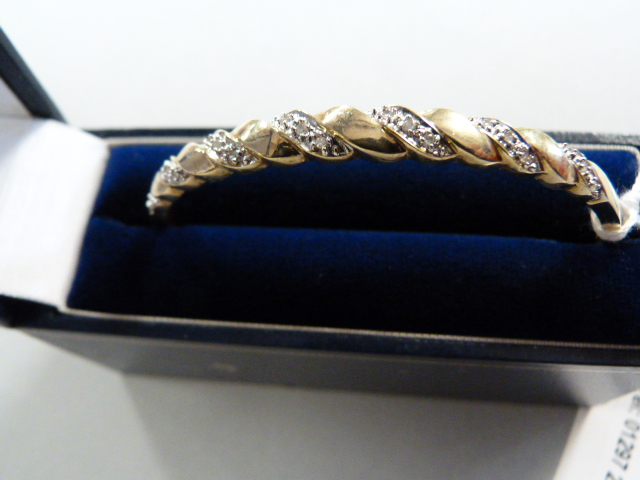 A 9ct hinged bangle set with diamonds - total weight 9.8g - Image 2 of 3