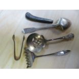 A hallmarked silver spoon, sugar tongs etc