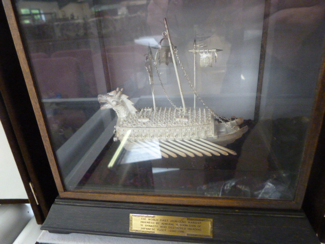 A Korean made silver coloured metal model of the world's first iron clad warship in wooden case