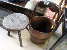A rice bucket and a carved wooden stool