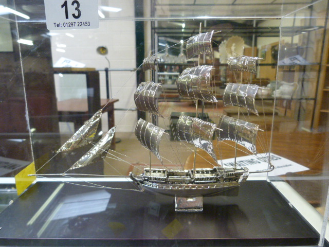 A silver model of a sailing ship in case. Small plaque to front stating "Silver 950"