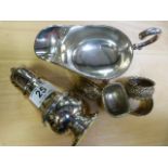 Three hallmarked silver serviette rings, plated sugar shaker and a sauceboat