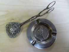 A continental hallmarked pair of grape pincers and a white metal dish.