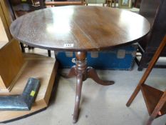 An oak tip top breakfast table on a pedestal base