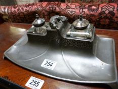 A stylised Art Nouveau pewter inkstand with fox finial